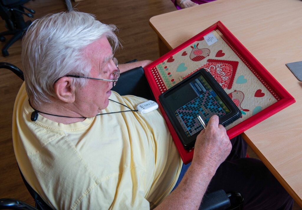 A man playing Scrabble on a tablet
