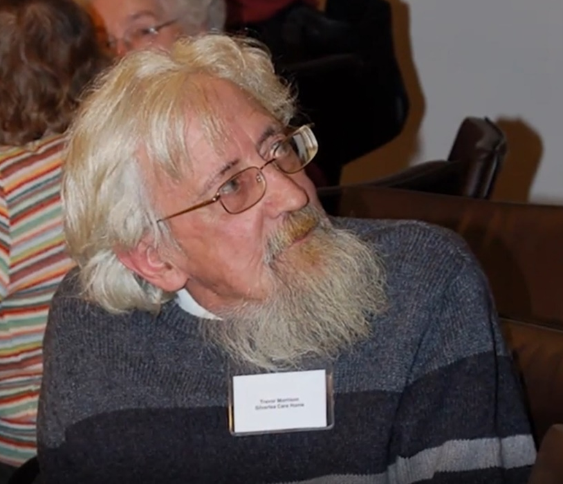 Man with long, white hair, a beard and glasses